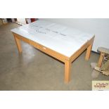 A beech effect coffee table with glass top