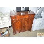 A reproduction mahogany cupboard fitted single dra