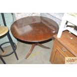 A mahogany circular topped table