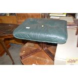 A green leather upholstered footstool