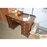 A mahogany desk fitted nine drawers