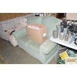 A light green upholstered two seater settee