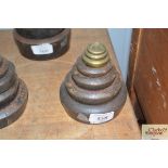 Seven graduated cast iron and brass shop weights,