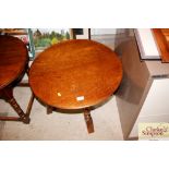 An oak circular topped side table