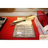 A cased set of six silver handled butter knives; t