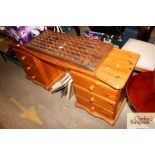 A modern pine knee hole desk fitted six drawers