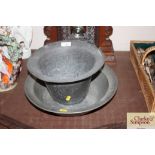 An antique pewter bowl and liner