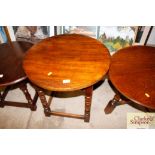 An oak circular topped side table