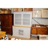 A good quality kitchen dresser raised on cupboard