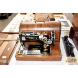 A Singer sewing machine in fitted case - sold as c