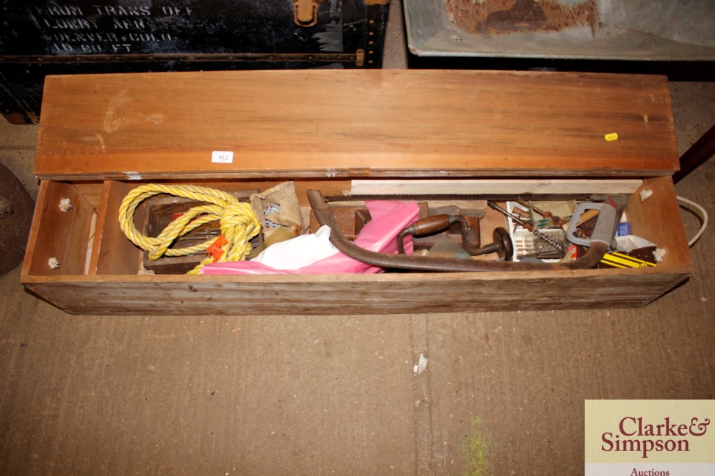 A wooden oblong storage box and contents of variou