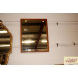 A teak wall mirror