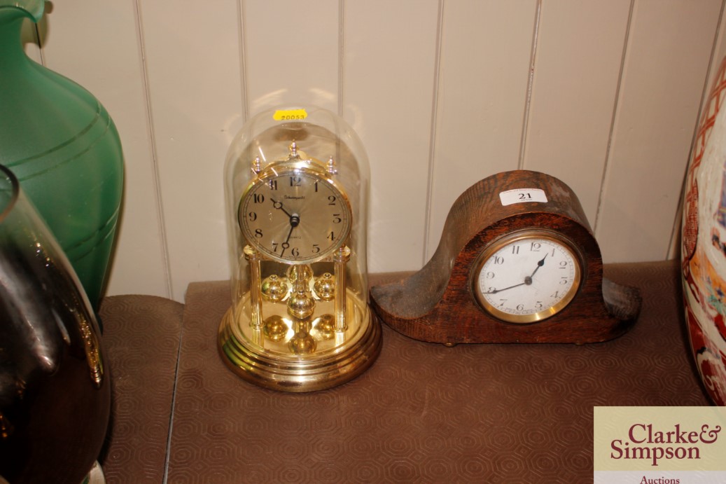 An anniversary clock; and a French oak cased mante