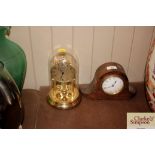 An anniversary clock; and a French oak cased mante