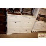 A white chest of eight drawers