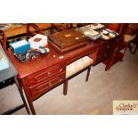 A kneehole dressing table and stool