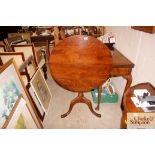 A 19th Century circular oak snap top occasional ta