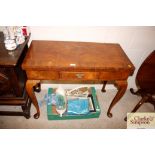 A walnut fold over card table on cabriole supports