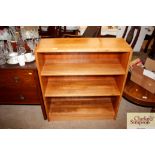 A teak open fronted bookcase