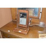 A small swing framed mirror