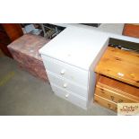 A modern bedside chest fitted three drawers