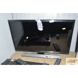 A Samsung flat screen TV with remote control