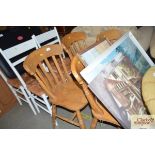 A set of four beech slat back dining chairs