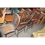 A pair of stick and wheel back carver chairs toget