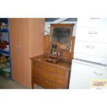 An oak mirrored back dressing chest fitted three l