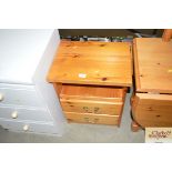 A pine bedside chest fitted two drawers