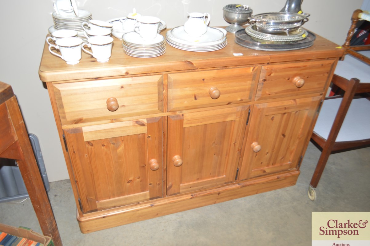 A modern pine sideboard fitted three drawers