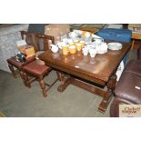 An oak draw leaf extending dining table with a set of four m