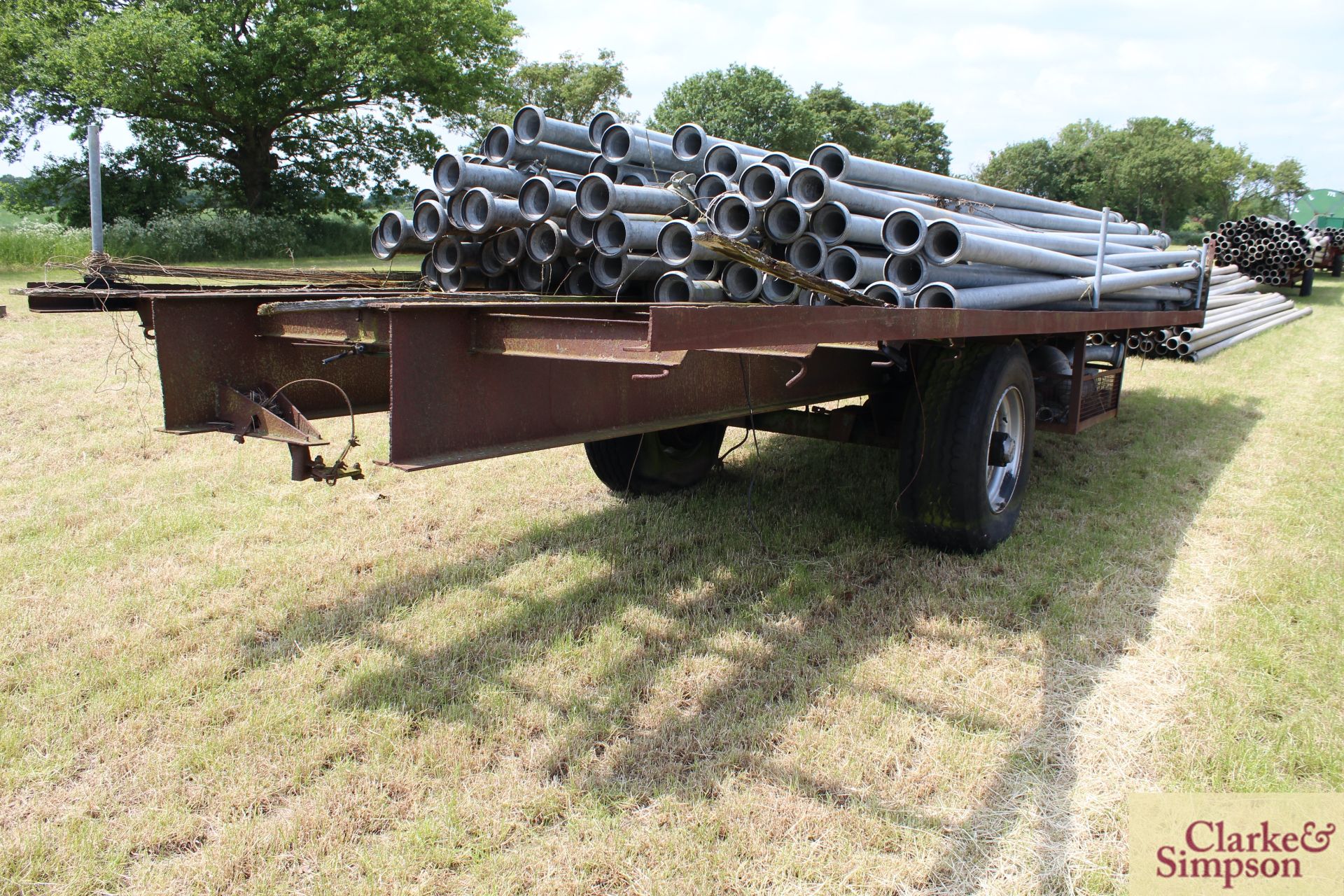 c. 7m single axle flat bed trailer. With super single wheels and tyres. Axle/ brakes stuck. Pipes - Image 3 of 11