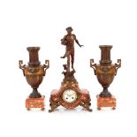 A French spelter and rouge marble three piece cloc