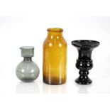 An amber glass cylindrical jar, 30cm high; a black