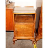 A mid 20th Century walnut bedside cabinet fitted recess and cupboar