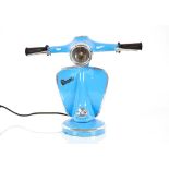 A table lamp in the form of a Vespa scooter