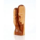 A Mid 20th Century carved wooden sculpture of male and female heads