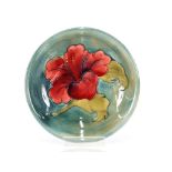 A Moorcroft "Hibiscus" pattern shallow dish on a s