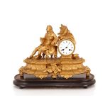 A 19th Century French gilded mantel clock decorated with a figu