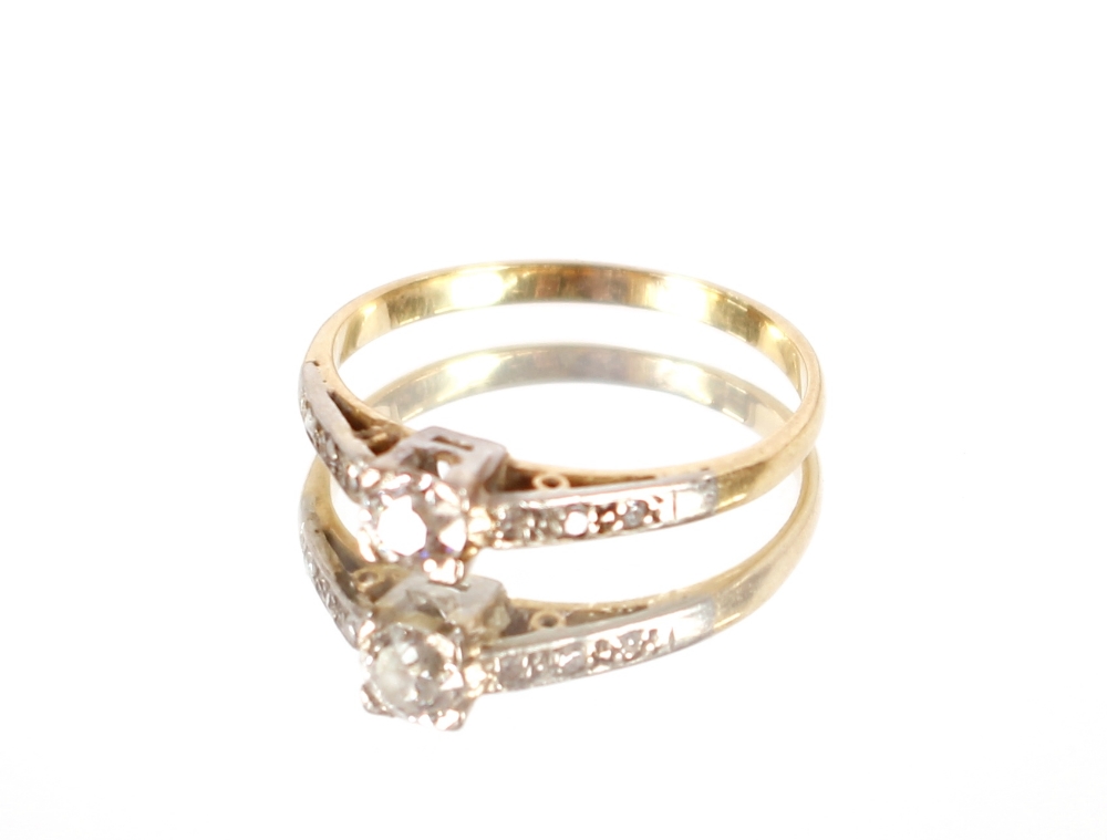 A yellow metal ring set central diamond and chip