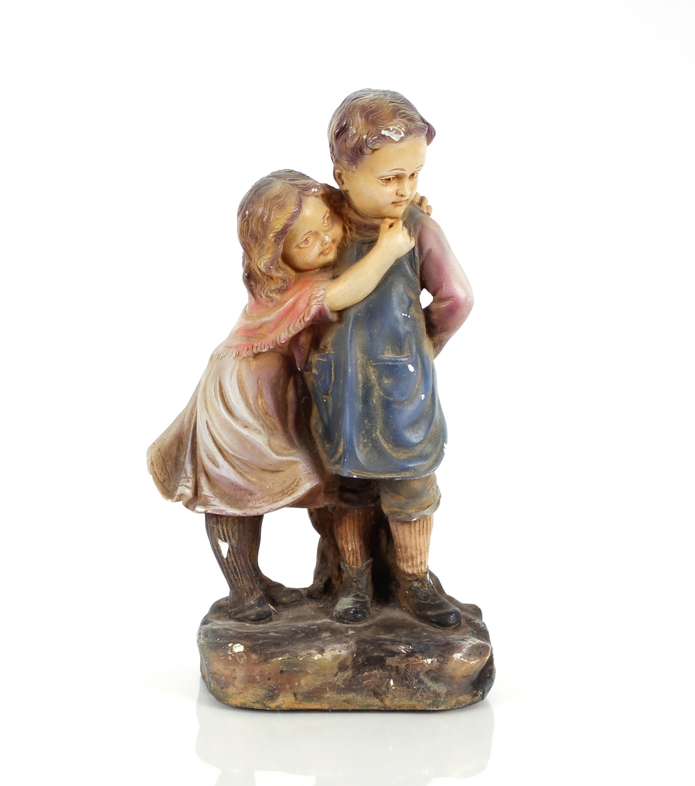 A plaster figure group depicting a boy and girl, 3