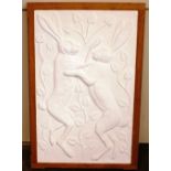 A decorative white plaster wall plaque, depicting
