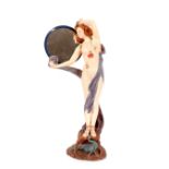 A large glazed plaster figure of a semi-naked lady