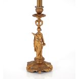 A 19th Century gilded candlestick in the form of a