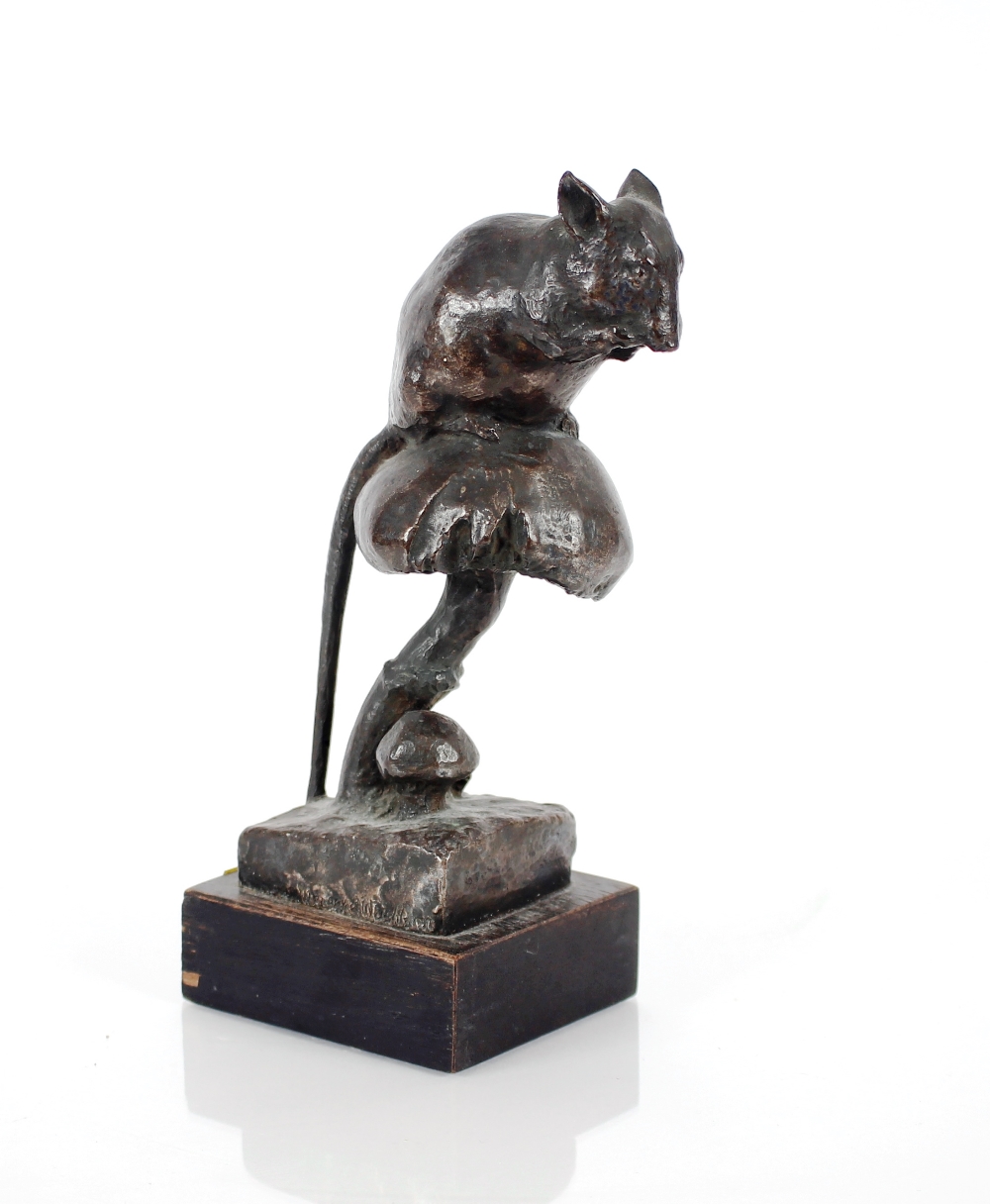 A bronze figure of a mouse seated on a toadstool,