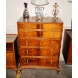 A mid 20th Century burr walnut chest of five long graduated drawers