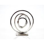 A chrome sculpture of concentric rings, 34cm high