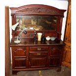 An early 20th Century carved walnut sideboard, the