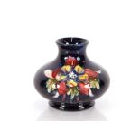 A Moorcroft "Columbine" pattern vase of compressed